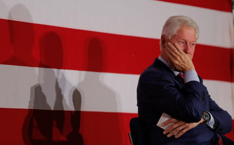 Bill Clinton takes part in a campaign event  - Credit: Reuters