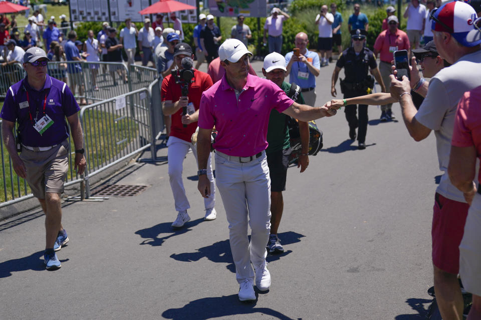 Rory McIlroy, of Northern Ireland, greets fans as he walks to the first tee during the third round of the Travelers Championship golf tournament at TPC River Highlands, Saturday, June 25, 2022, in Cromwell, Conn. (AP Photo/Seth Wenig)