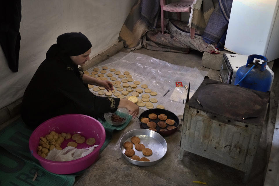 A Syrian mother bakes traditional cookies inside her tent ahead of Eid al-Adha celebrations at a refugee camp in the town of Bar Elias, in the Bekaa Valley, Lebanon, July 7, 2022. The Lebanese government’s plan to start deporting Syrian refugees has sent waves of fear through vulnerable refugee communities already struggling to survive in their host country. Many refugees say being forced to return to the war shattered country would be a death sentence. (AP Photo/Bilal Hussein)