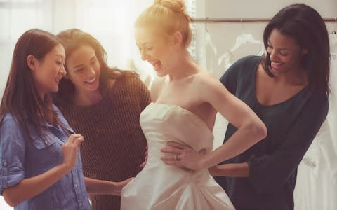 Bride and friends shopping for wedding gown - Credit: Jose Luis Pelaez Inc