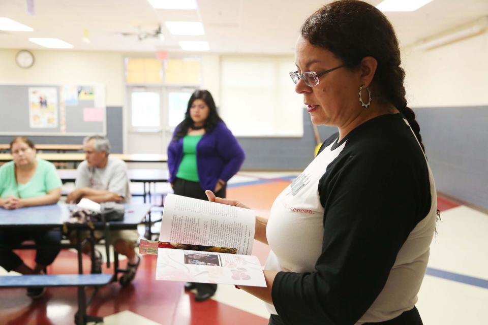 Dawn Martinez Oropeza, executive director of Al Exito, a program for Latino middle school, high school and college students, talks about the book published by the organization called The Ones I Bring With Me: Lose Que Llevo Conmigo during a meeting on Tuesday, May 26, 2015 at Carver Elementary. The book shares the stories of Latina girls growing up in Iowa with a focus on their educational journey. 