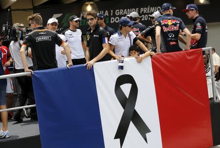 Formula One drivers participate in a parade in tribute to the victims of the Paris attacks, before the Brazilian F1 Grand Prix in Sao Paulo, Brazil, November 15, 2015. REUTERS/Nacho Doce