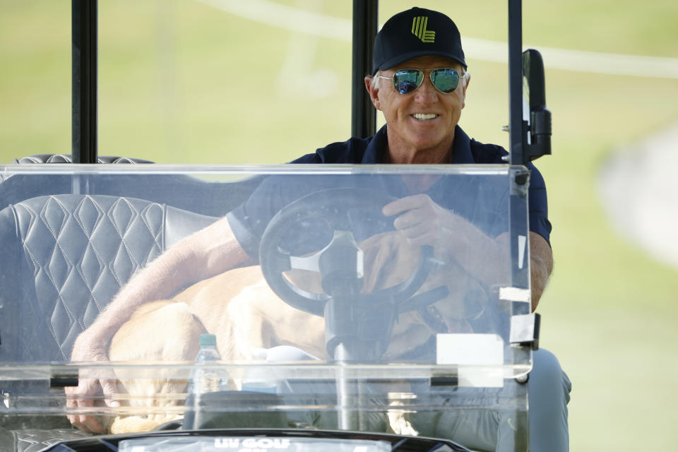 Greg Norman and friend at the LIV Golf Miami season-ending event. (Cliff Hawkins/Getty Images)
