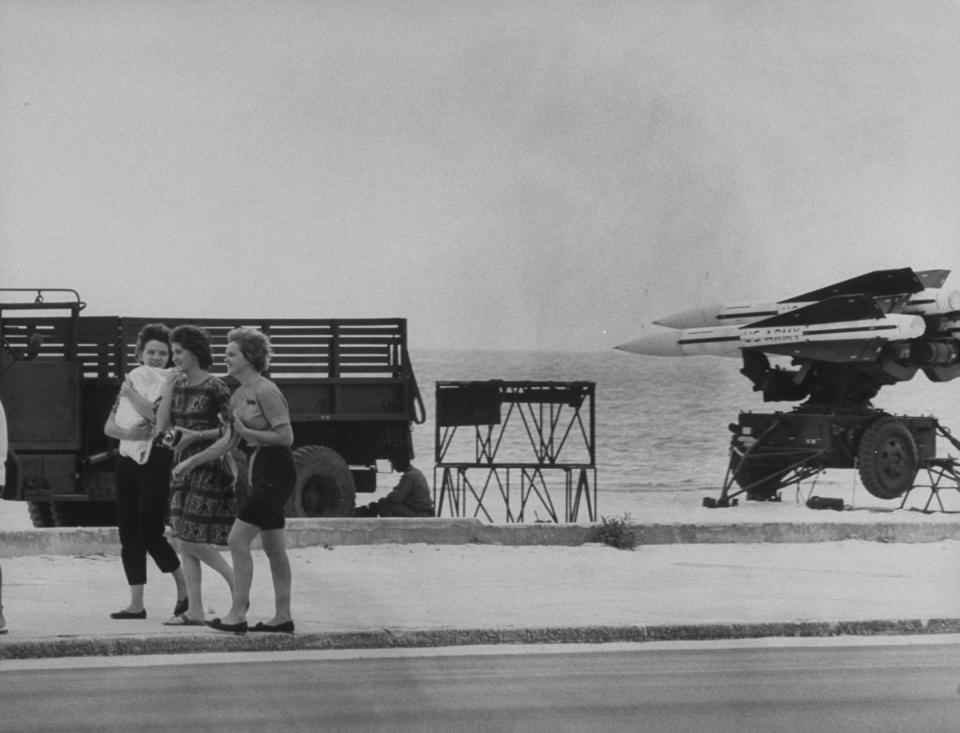 women walking past us army hawk missiles