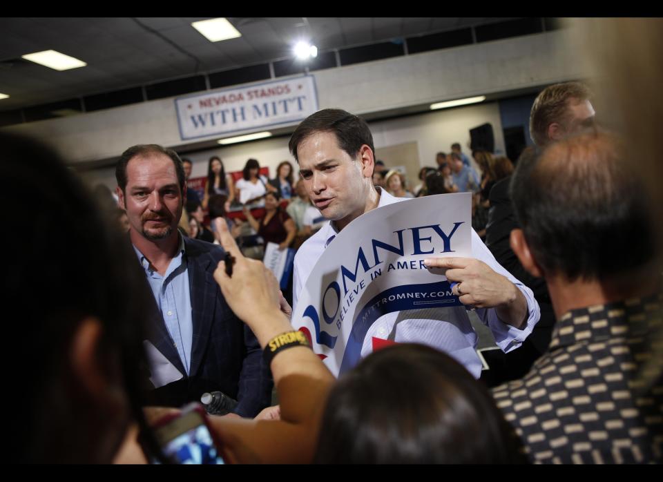 Sen. Marco Rubio, R-Fla., signs a Romney sign for a supporter at a rally for presidential candidate Mitt Romney at C.C. Ronnow Elementary School in Las Vegas Saturday, July 28, 2012. (AP Photo/Las Vegas Review-Journal, John Locher) LOCAL TV OUT; LOCAL INTERNET OUT; LAS VEGAS SUN OUT