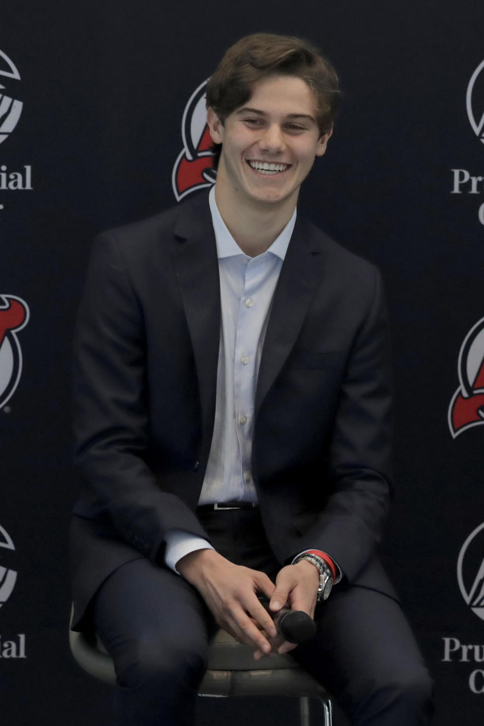 New Jersey Devils forward Jack Hughes, the No. 1 overall pick in the 2019 NHL hockey draft, reacts during a news conference introducing the prospect to local media, Tuesday, June 25, 2019, in Newark, N.J. (AP Photo/Julio Cortez)