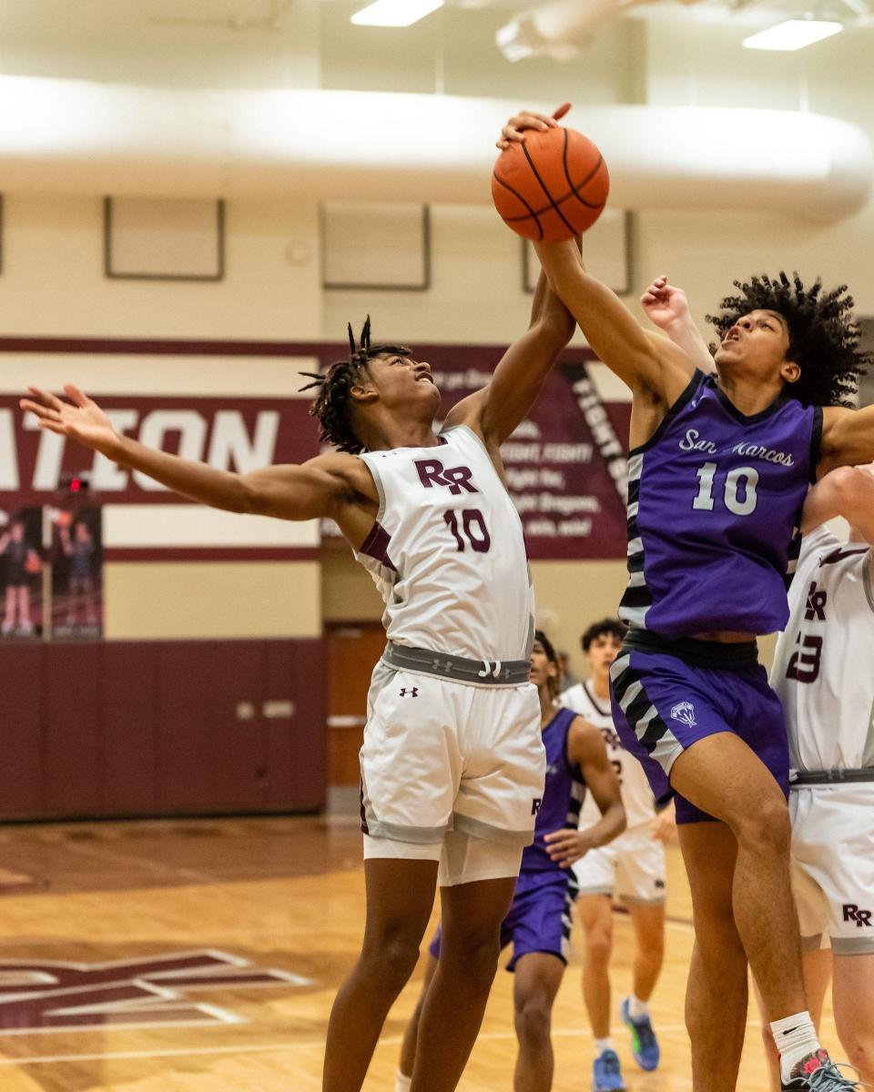 Mateus Perkins of San Marcos, right, battles for a rebound against Round Rock's Leonard Moore in a game earlier this week. Perkins is one of the top rebounders in the area.