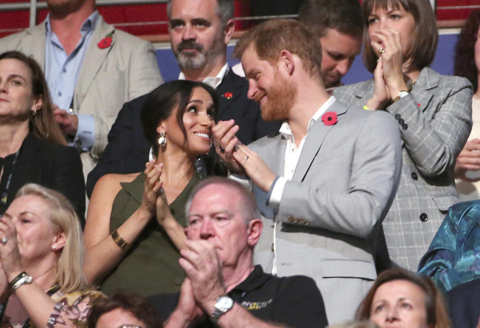 The Duchess and Duke of Sussex clap during the closing ceremonies for the Invictus Games in Sydney, Oct. 27, 2018. (Photo: Rick Rycroft/AP)