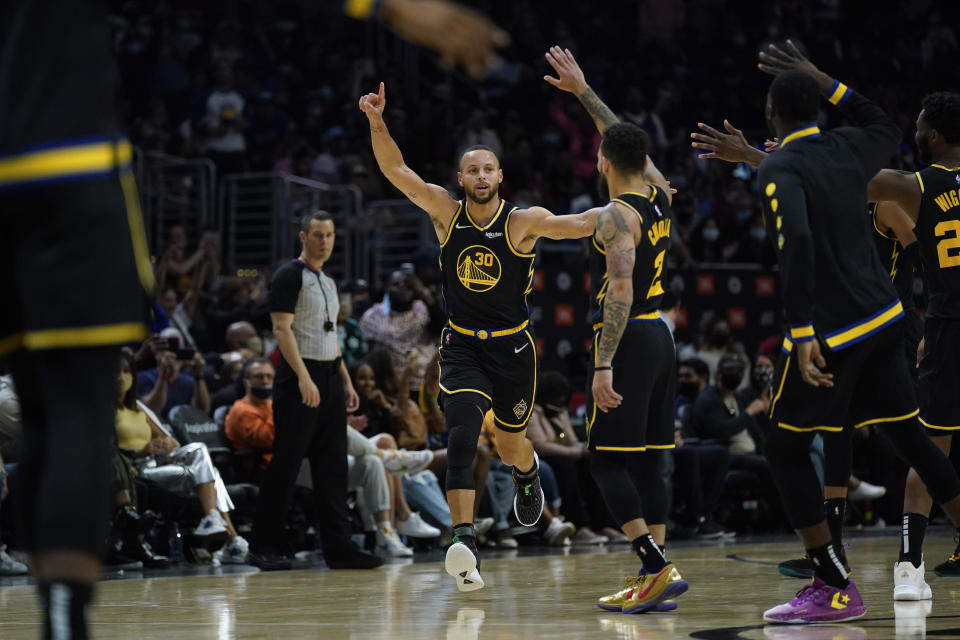 Golden State Warriors guard Stephen Curry (30) celebrates after making a three-pointer during the second half of an NBA basketball game in Los Angeles, Sunday, Nov. 28, 2021. (AP Photo/Ashley Landis)