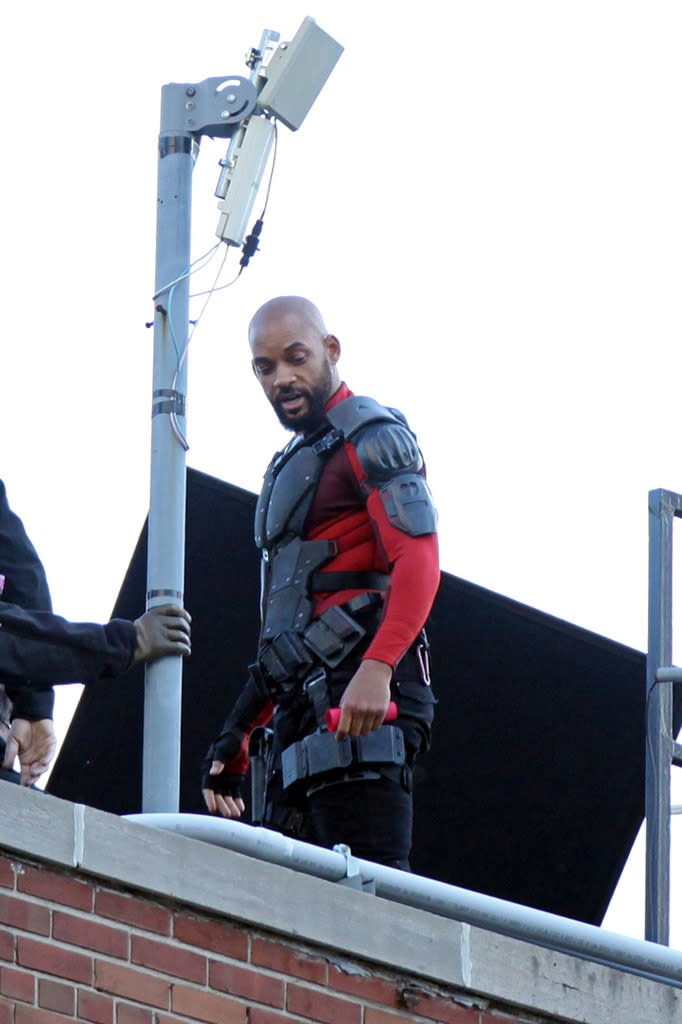 <p>Will Smith is seen hanging off the side of a building as Deadshot on June 6.</p>