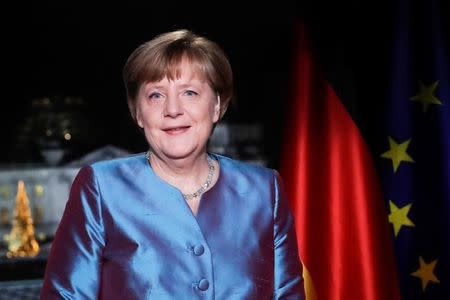 German Chancellor Angela Merkel poses for photographs after the television recording of her annual New Year's speech at the Chancellery in Berlin, Germany, December 30, 2016. REUTERS/Markus Schreiber/Pool