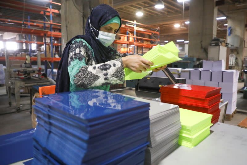 A worker works at Oriental Paper Products, a stationery factory in Fanar