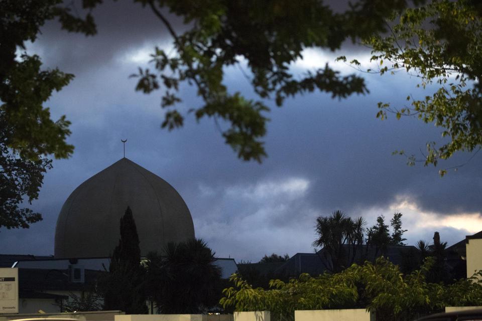 Al Noor mosque is shaded by clouds in Christchurch, New Zealand, Tuesday, March 19, 2019. Streets near the hospital that had been closed for four days reopened to traffic as relatives and friends of the victims of last week's mass shootings continued to stream in from around the world. (AP Photo/Vincent Thian)