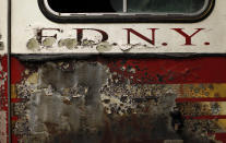 A portion of a New York City Fire Department engine recovered from the World Trade Center disaster site sits inside Hangar 17 at New York's John F. Kennedy International Airport June 16, 2011. A program operated by the Port Authority of New York and New Jersey, The World Trade Center steel program, is selecting portions of the steel recovered from the Center and donating it to cities, towns, firehouses and museums around the U.S. and the world who request it for use in 911 memorial sites in time for the 10 year anniversary of the 2001 attacks. Picture taken June 16, 2011. (REUTERS/Mike Segar)