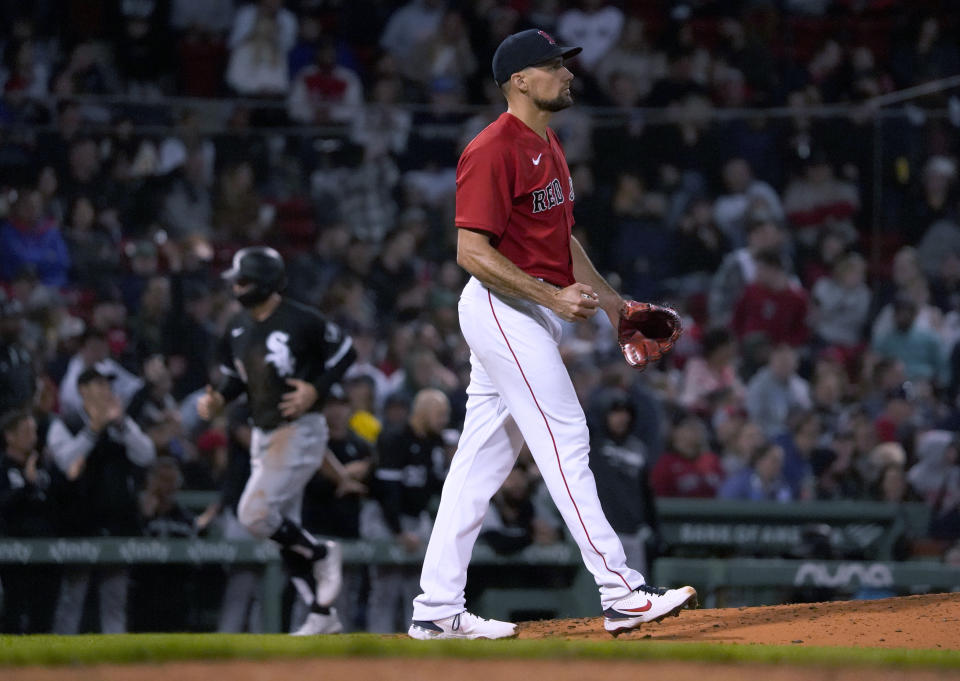 Boston Red Sox starting pitcher Nathan Eovaldi walks near the mound as Chicago White Sox's AJ Pollock rounds third base to score on a two-run home run by Luis Robert during the third inning of a baseball game at Fenway Park, Friday, May 6, 2022, in Boston. (AP Photo/Mary Schwalm)