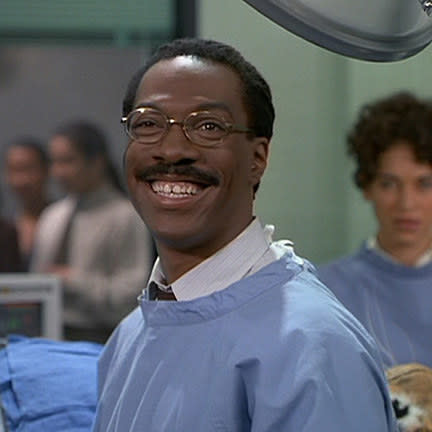 Eddie Murphy grinning and wearing scrubs