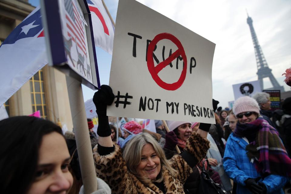 Protesters carrying banners and placards take part in a Women's March next to the Eiffel Tower, in Paris, France, Saturday, Jan. 21, 2017. The march is part of a worldwide day of actions following the inauguration of U.S President Donald Trump. (AP Photo/Christophe Ena)