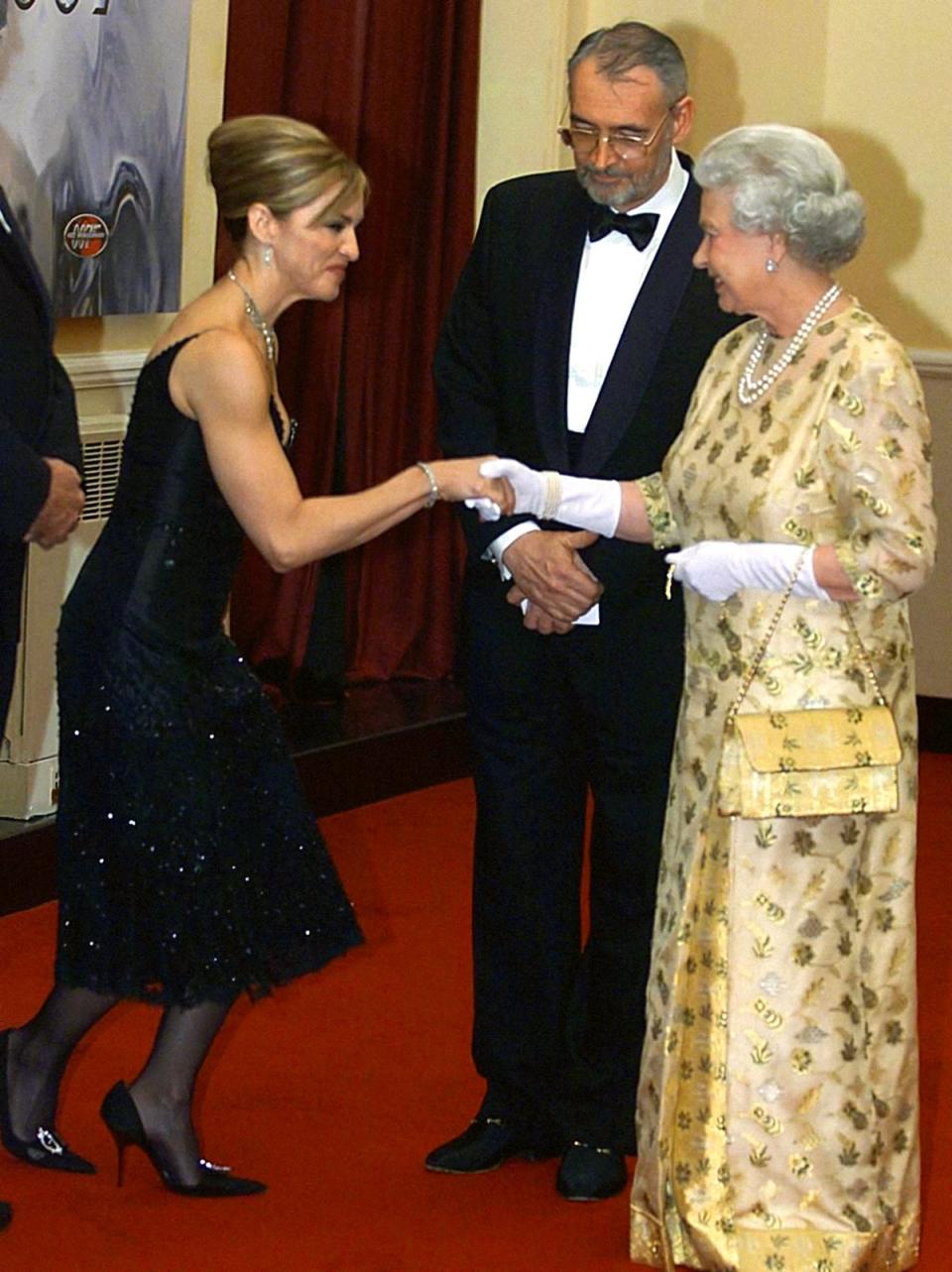 Madonna curtsying to the Queen at the world premiere of the James Bond film Die Another Day in 2002 (PA) (PA Archive)