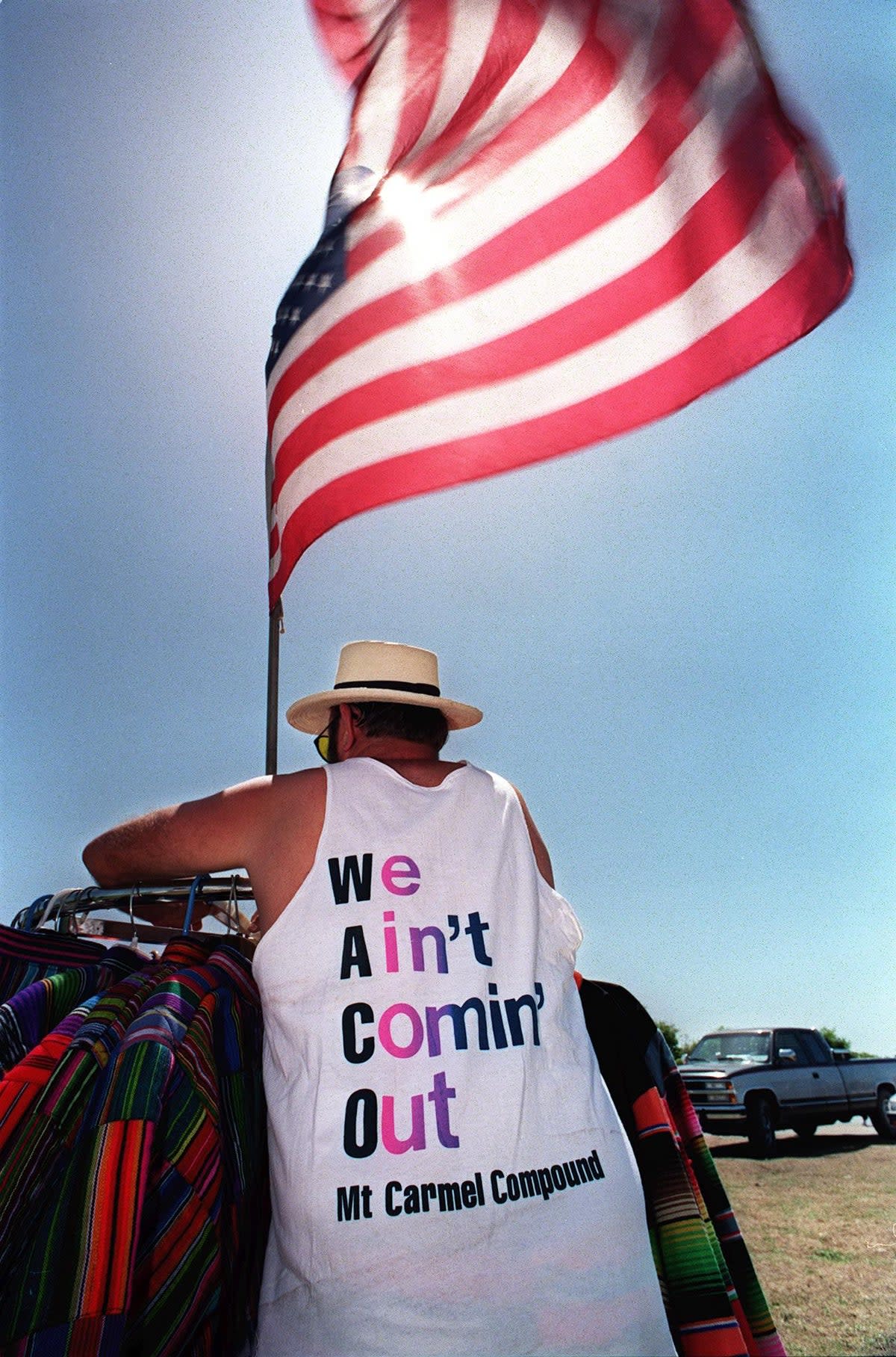 A t-shirt salesman shown in a file photo dated 10 April 1993 near the Branch Davidians' compound in Waco (BOB DAEMMRICH/AFP FILES/AFP via Getty Images)