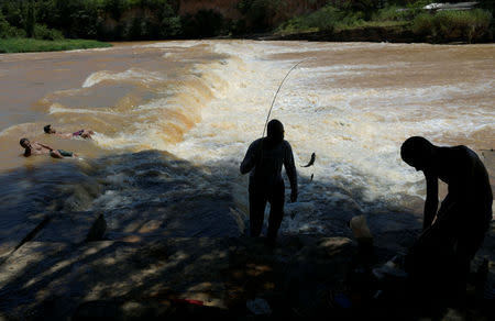 Residents fish on Paraopeba River after a tailings dam owned by Brazilian mining company Vale SA collapsed, in Curvelo near Brumadinho, Brazil Februarary 11, 2019. REUTERS/Washington Alves