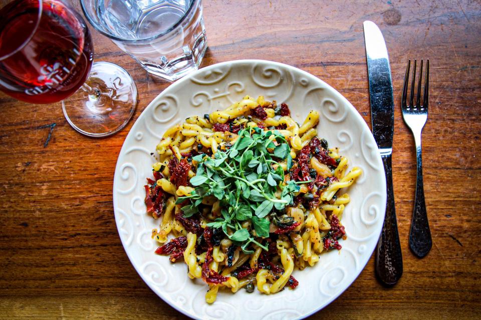 Gemelli Fresca is a vegetarian dish with Gemelli pasta, sundried tomato, capers, roasted garlic, rosemary and preserved lemon. It can be ordered gluten-free and vegan. Added options are chicken, beef, shrimp, veggie and spiedini (marinated and grilled skewers).