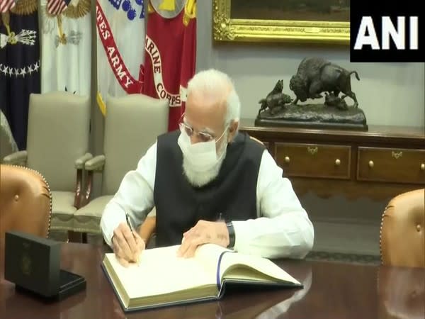 Prime Minister Narendra Modi signing the visitors' book in the Roosevelt Room of the White House.