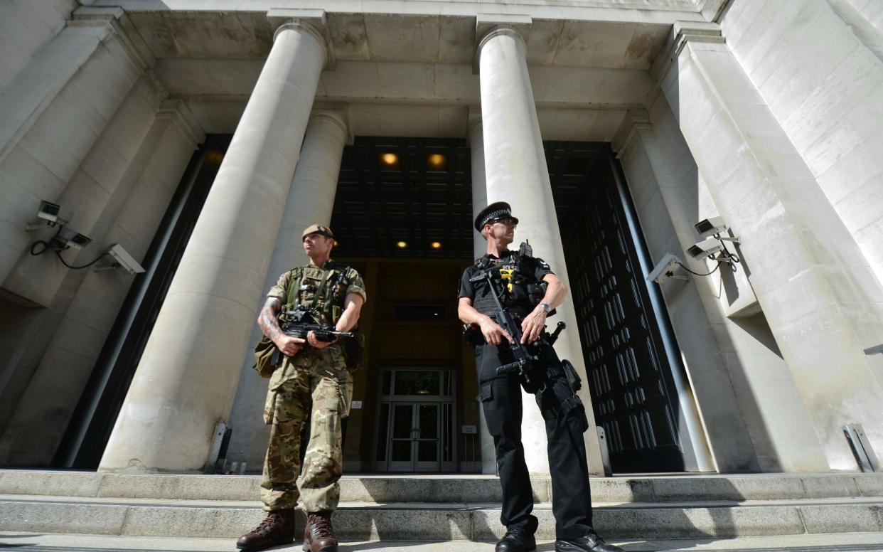 A soldier joins a police officer outside the Ministry of Defence - Victoria Jones/PA Wire/Victoria Jones/PA Wire