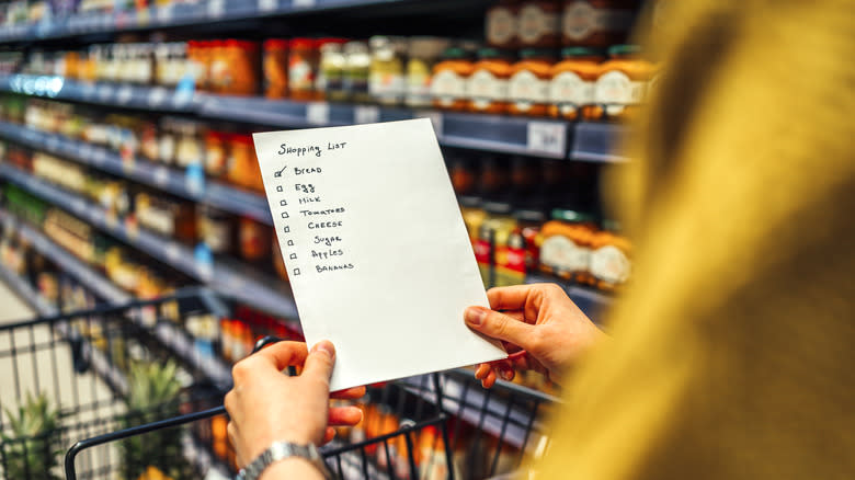 person holding a grocery list