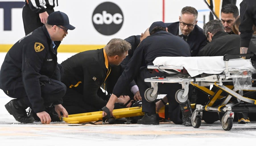 The medical staff tends to referee Steve Kozari after he and Tampa Bat Lightning’s Haydn Fleury collided in the third period of an NHL hockey game in Pittsburgh, Saturday, April 6, 2024. (Chaz Palla/Pittsburgh Tribune-Review via AP)