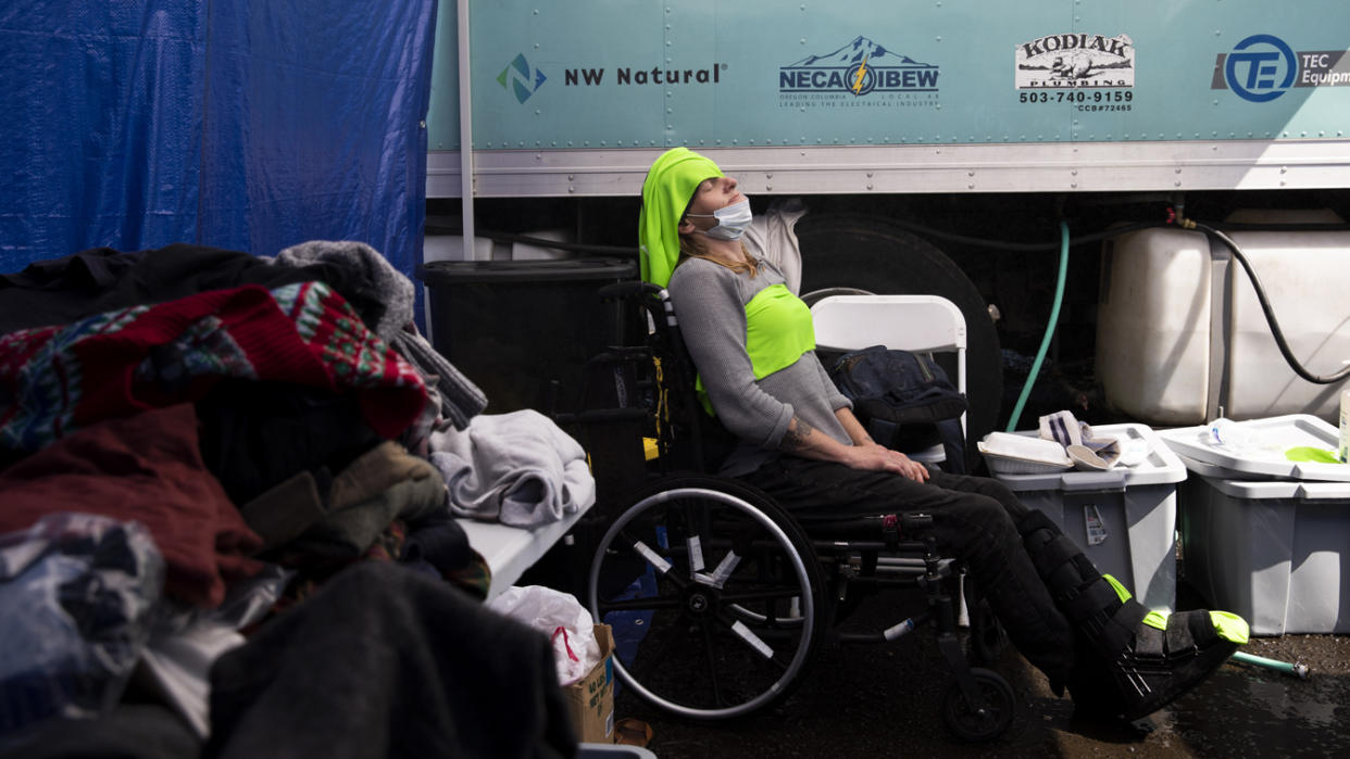 Tracy Wallace, 42, puts ice cold cloths on her forehead and chest to stay cool at the Sunrise Center cooling center in Portland, Oregon on June 27, 2021. (Alisha Jucevic/The Washington Post via Getty Images)