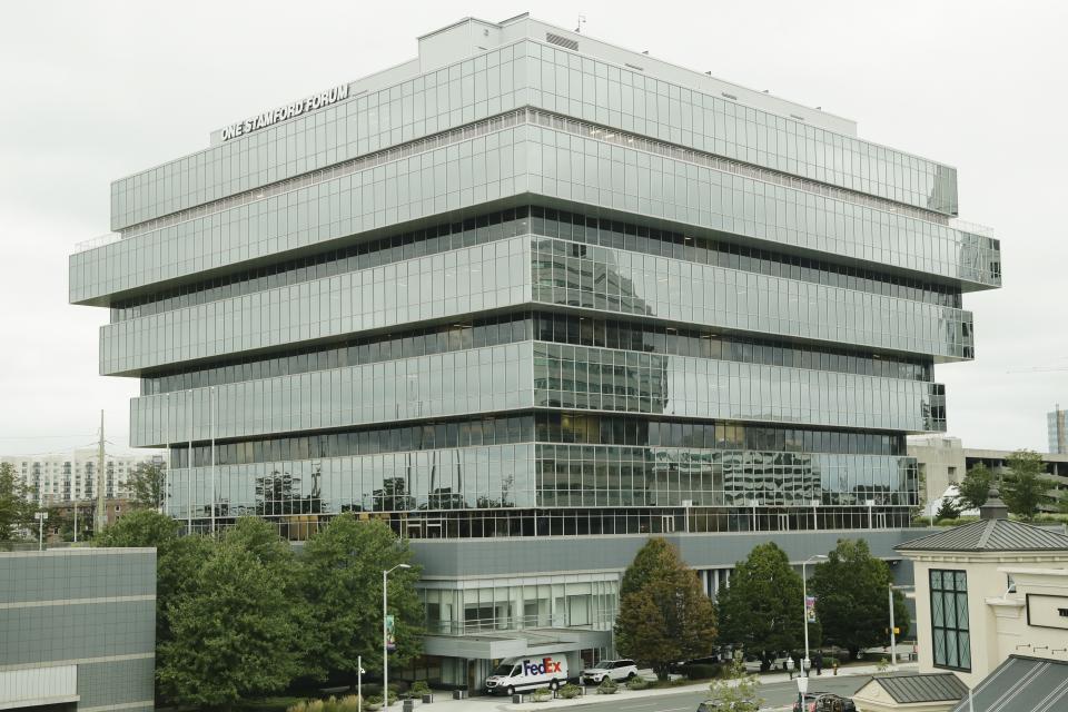 Cars pass Purdue Pharma headquarters Thursday, Sept. 12, 2019, in Stamford, Conn. For months, the judge overseeing national litigation over the opioids crisis urged all sides to reach a settlement that could end thousands of lawsuits filed by state and local governments. But the chaotic developments this week in the case against OxyContin maker Purdue Pharma underscore how difficult that goal is. (AP Photo/Frank Franklin II)