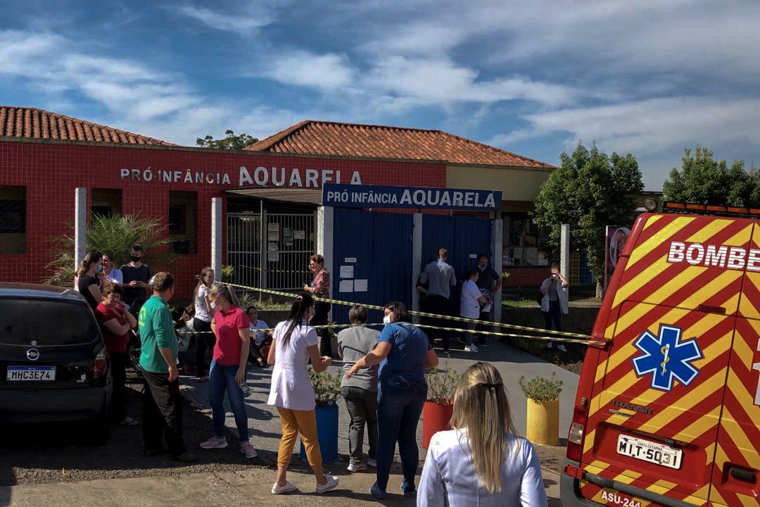 <p>Photo released by Brazilian newspaper Imprensa do Povo showing people and local authorities at the surroundings of the Aquarela Daycare School</p> (Impresa do Povo/AFP via Getty Images)