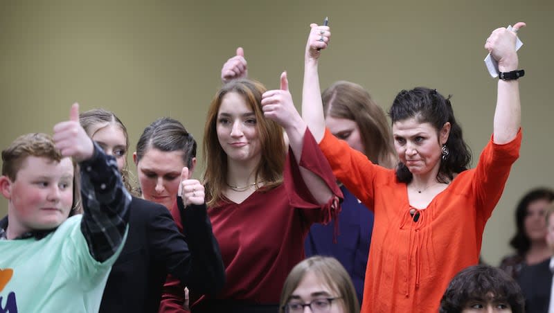 Elissa Ludlum, right, and others give a thumbs-up after hearing public comments concerning the Utah Fits All Scholarship during a House Education Committee hearing concerning HB215 at the Capitol in Salt Lake City on Thursday, Jan. 19, 2023.