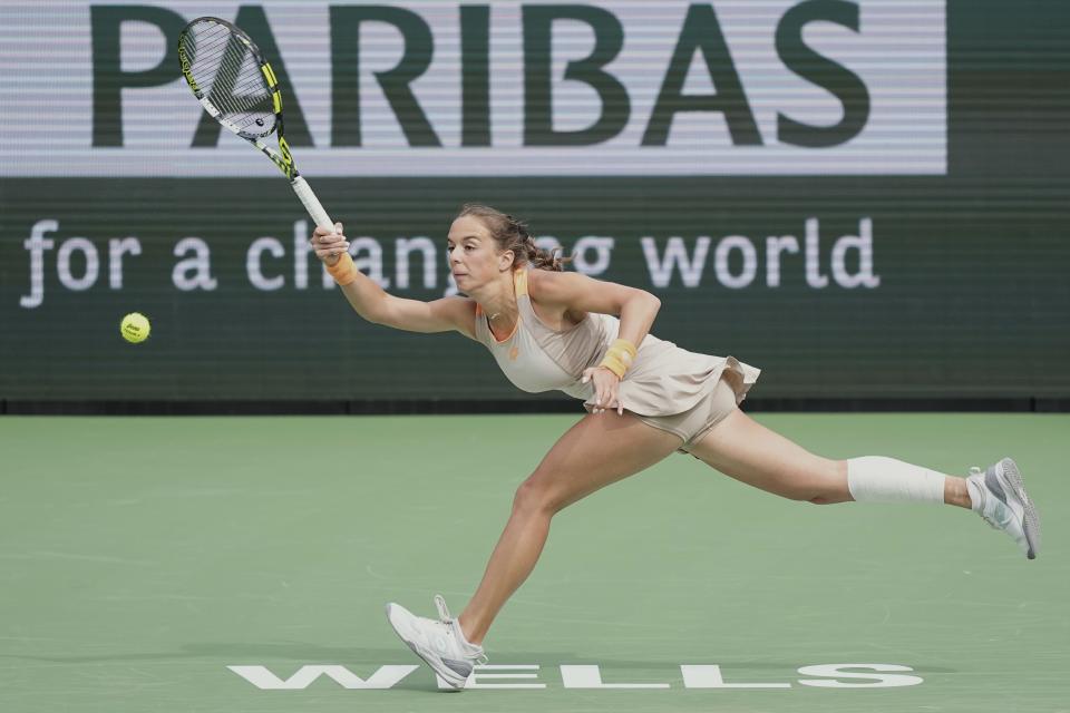Lucia Bronzetti, of Italy, returns a shot to Coco Gauff, of the United States, at the BNP Paribas Open tennis tournament Monday, March 11, 2024, in Indian Wells, Calif. (AP Photo/Mark J. Terrill)