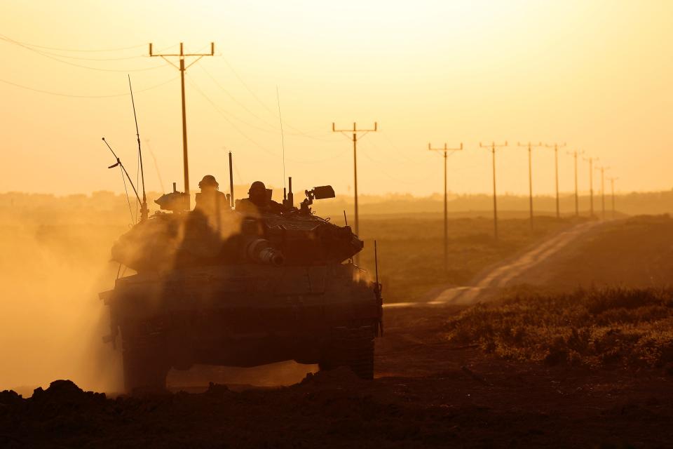 A picture taken from Israel near the border with the Gaza Strip on March 6, 2024 shows an Israeli army tank moving along the border area, as battles between Israel and the Palestinian militant group Hamas continue.