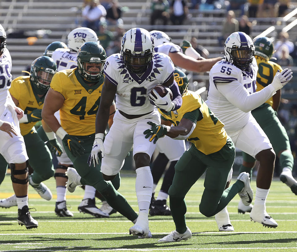 TCU running back Zach Evans (6) runs through the Baylor defense in the first half of an NCAA college football game in Waco, Texas, Saturday, Oct. 31, 2020. (Jerry Larson/Waco Tribune-Herald via AP)