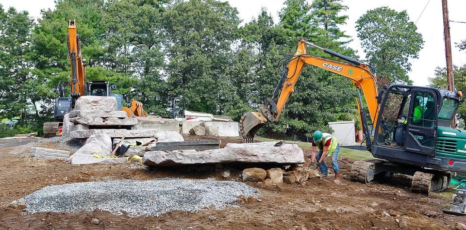 A new granite waterfall under construction at an entrance to Pine Hill Cemetery.