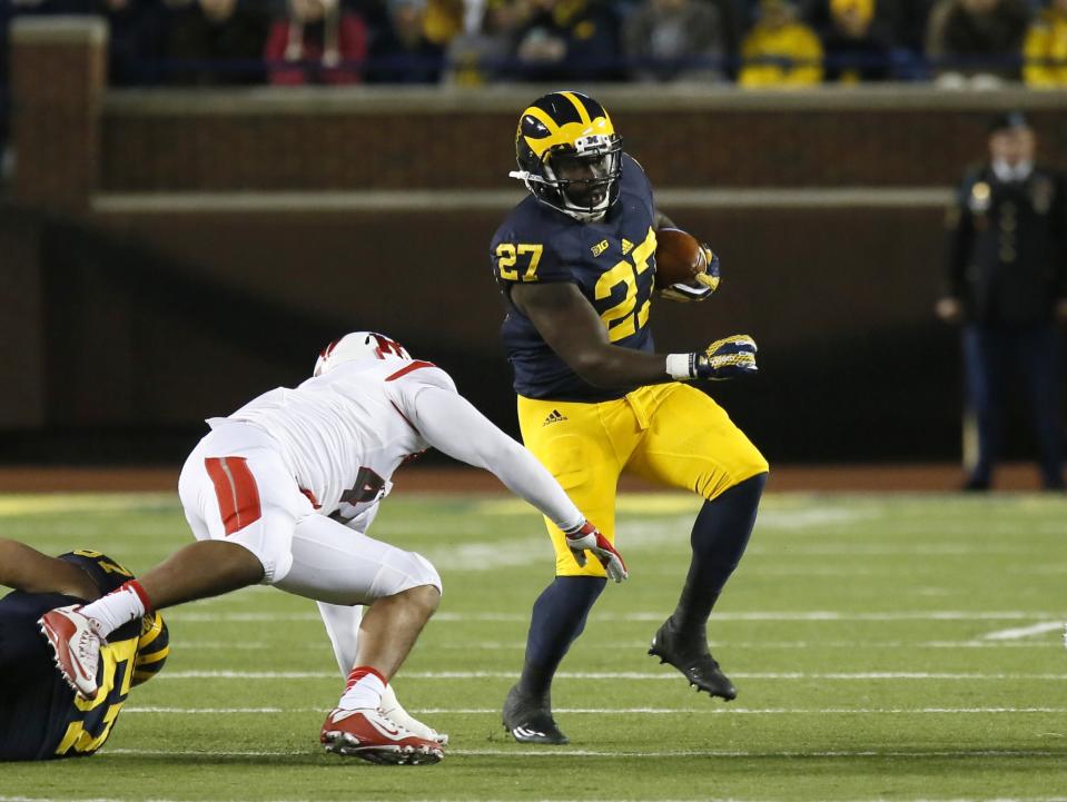 Michigan's Derrick Green (27) avoids Rutgers' Isaiah Johnson (47) while carrying the ball during the second half of an NCAA college football game Saturday, Nov. 7, 2015, in Ann Arbor, Mich. Michigan defeated Rutgers 49-16. (AP Photo/Duane Burleson)