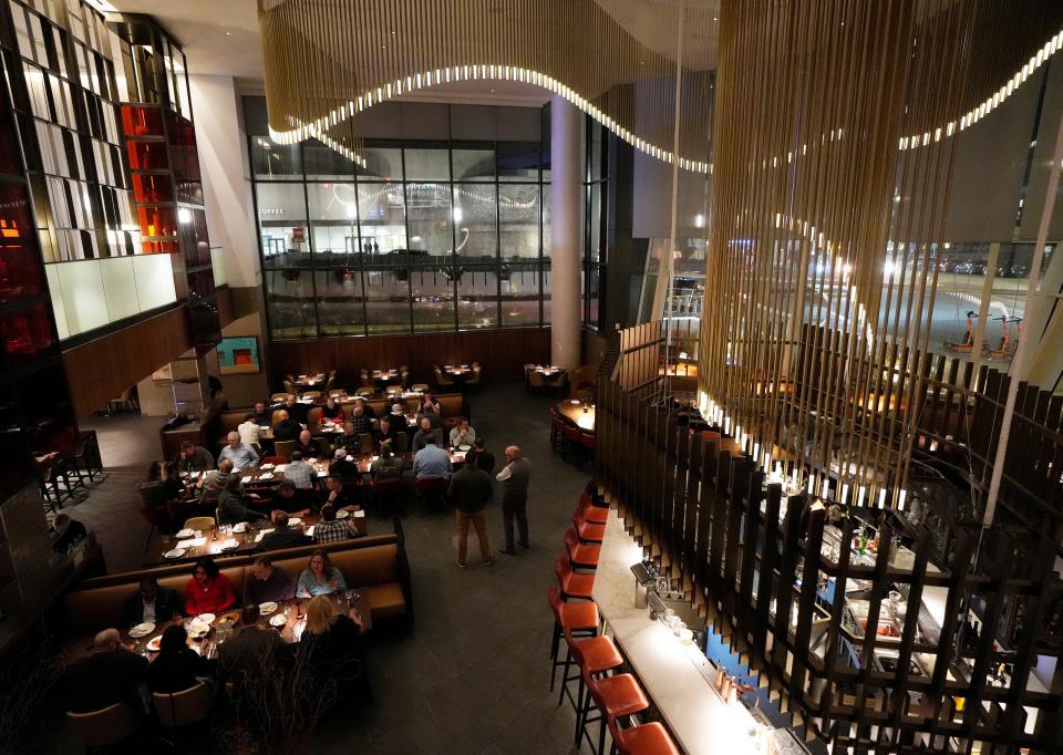 A view from above, looking down on the dining room of Fyr at the Hilton Columbus Downtown. The interior is dark, warm and intimate.