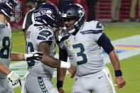 Seattle Seahawks running back Carlos Hyde (30) celebrates his touchdown with quarterback Russell Wilson (3) during the first half of an NFL football game against the Arizona Cardinals, Sunday, Oct. 25, 2020, in Glendale, Ariz. (AP Photo/Rick Scuteri)