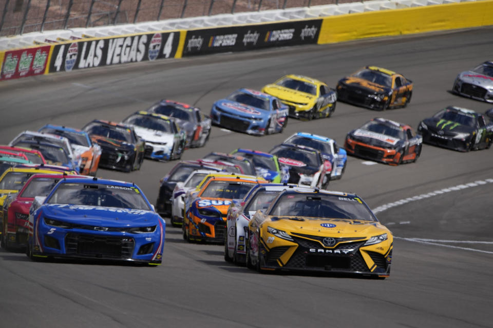 Cars race during a NASCAR Cup Series auto race Sunday, March 6, 2022, in Las Vegas. (AP Photo/John Locher)