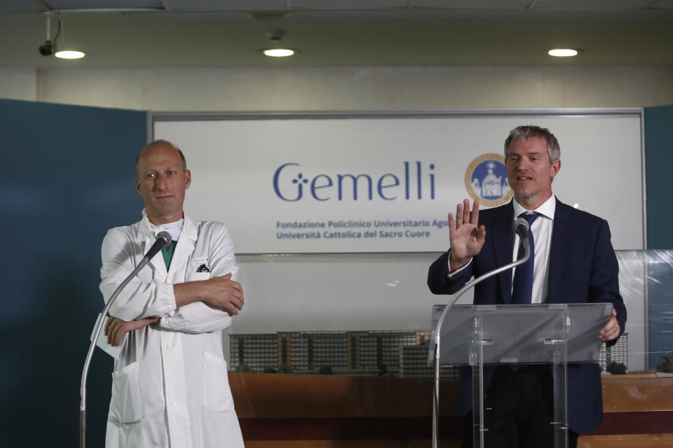 Surgeon Sergio Alfieri left, listens to Pope's spokesperson Matteo Bruni talking to reporters about Pope Francis' health conditions after operating on him at Rome's Agostino Gemelli University Polyclinic, Wednesday, June 7, 2023. Pope Francis underwent surgery Wednesday to repair a hernia in his abdominal wall, the latest malady to befall the 86-year-old pontiff who had part of his colon removed two years ago. (AP Photo/Riccardo De Luca)