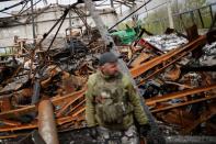 A Ukrainian army soldier looks at a destroyed shed, amid Russia's invasion of Ukraine, in the Zaporizhzhia region