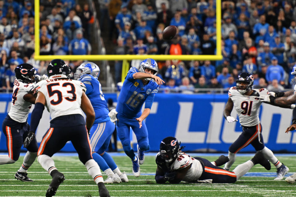 DETROIT, MI - NOVEMBER 19: Detroit Lions quarterback Jared Goff (16) just gets away a pass being tripped by Chicago Bears defensive tackle Gervon Dexter Sr. (99) during the Detroit Lions versus the Chicago Bears game on Sunday November 19, 2023 at Ford Field in Detroit, MI. (Photo by Steven King/Icon Sportswire via Getty Images)