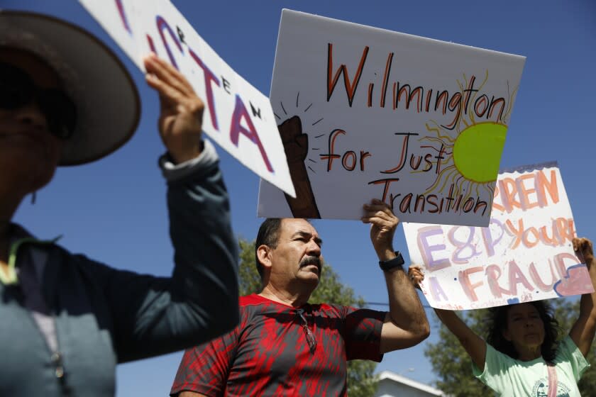 WILMINGTON-CA-JUNE 1, 2022: Wilmington residents including Guadalupe Diaz, left, and her husband Carlos, center, with community organizer Alicia Rivera, right, join Communities for a Better Environment, Standing Together Against Neighborhood Drilling, and U.S. Congresswoman Nanette Barragan at a news conference to allege illegal oil drilling in Wilmington and demand the city of Los Angeles take action against oil operator Warren Resources on Wednesday, June 1, 2022. (Christina House / Los Angeles Times)