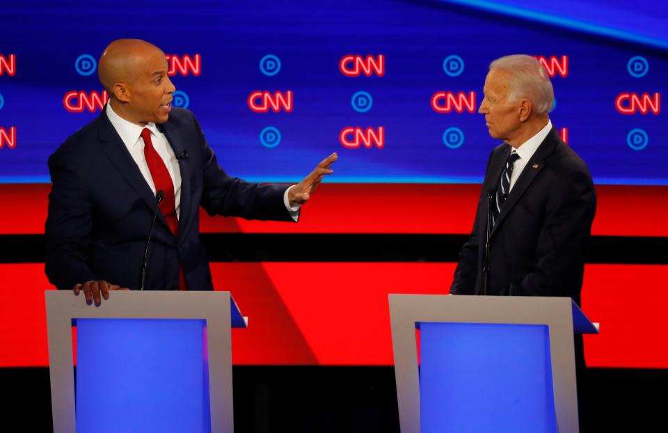 Sen. Cory Booker speaks to former Vice President Joe Biden during the second of two Democratic presidential primary debates on July 31, 2019, in Detroit.