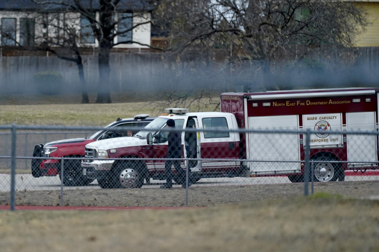 Emergency responders gather at Colleyville Elementary School near Congregation Beth Israel synagogue on Saturday, Jan. 15, 2022, in Colleyville, Texas. Authorities said a man took hostages Saturday during services at the Texas synagogue where the suspect could be heard ranting in a livestream and demanding the release of a Pakistani neuroscientist who was convicted of trying to kill U.S. Army officers in Afghanistan. (AP Photo/Tony Gutierrez)