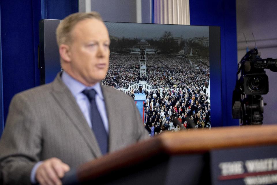 FILE - In this Jan. 21, 2017 file photo, an image of the inauguration of President Donald Trump is displayed behind White House press secretary Sean Spicer as he speaks at the White House in Washington. (AP Photo/Andrew Harnik, File)
