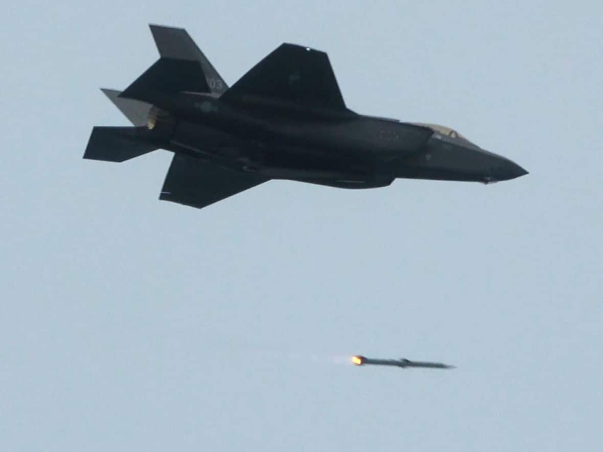 A South Korean F-35A fighter jet fires an air-to-air missile during a joint aerial drill between South Korea and the United States in South Korea on Friday. Canada plans to invest more than $7 billion in upgrading fighter jet bases and Far North landing strips to accommodate the new F-35s. (South Korea Defense Ministry via AP - image credit)