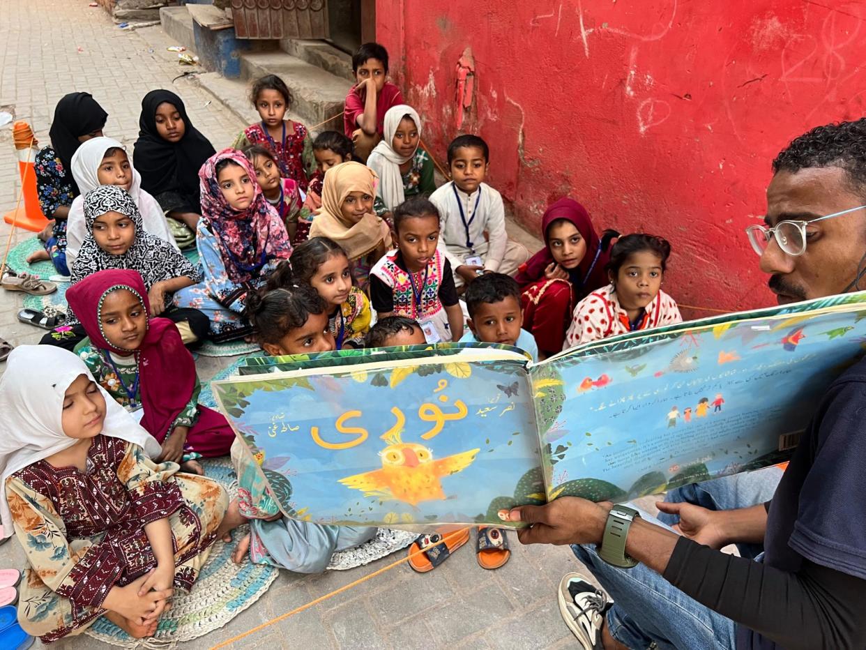 <span>‘We cannot expect children to want to read if we don’t read to them first’ - storytelling in the alleyways of Karachi.</span><span>Photograph: Zofeen E Ebrahim/The Guardian</span>